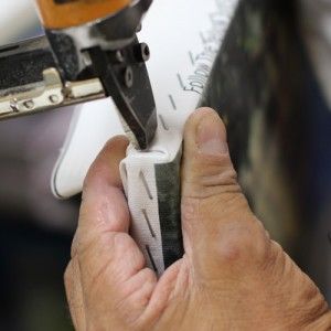 Close up of stitching a gallery wrapped canvas